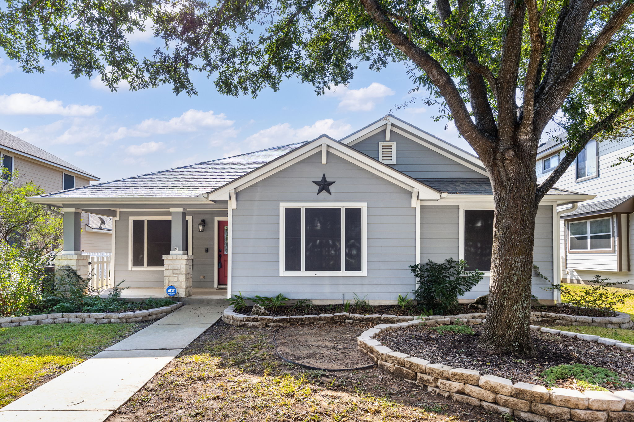 784 Sampson Kyle, TX 78640 - Photo 1 of 40 A paved walkway leads past neat stone-bordered garden beds to the inviting front porch.