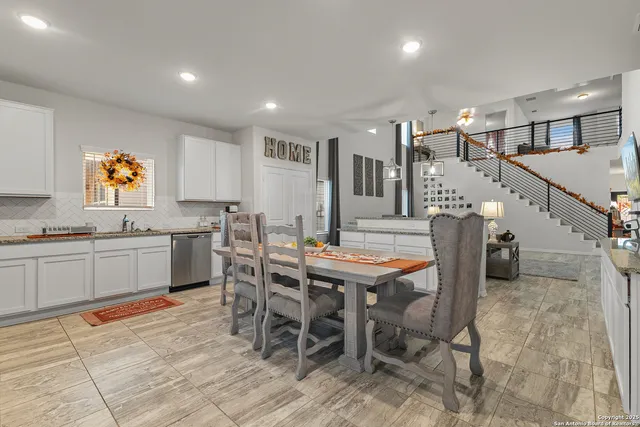 a open dining room with stainless steel appliances kitchen island granite countertop a table and chairs