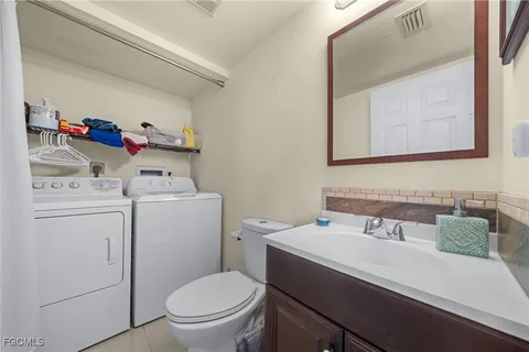 a bathroom with a sink toilet and vanity