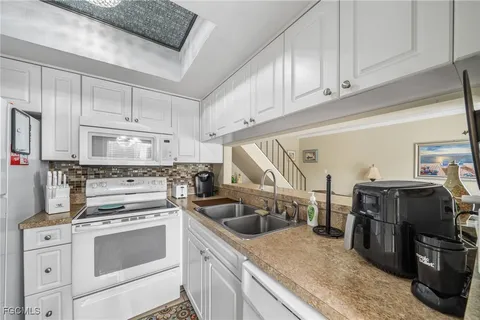 a kitchen with stainless steel appliances granite countertop a sink and cabinets