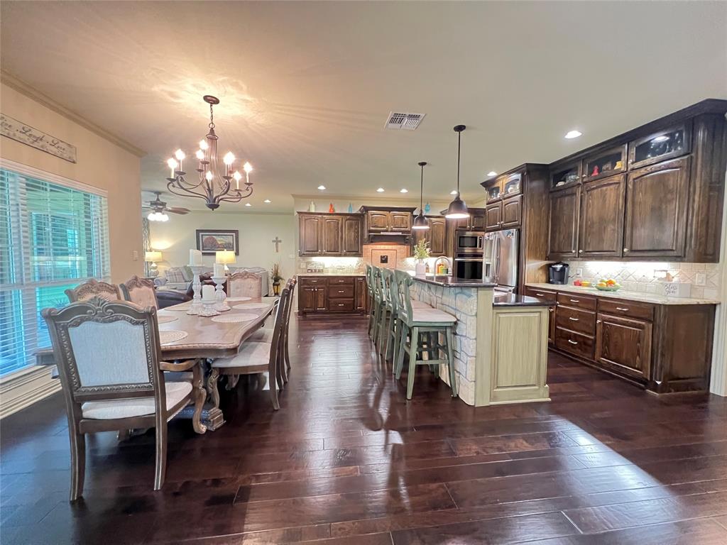 187 Private Road 5987 Yantis, TX 75497 - Photo 24 of 40 Dining room with dark hardwood / wood-style floors, ornamental molding, and ceiling fan with notable chandelier