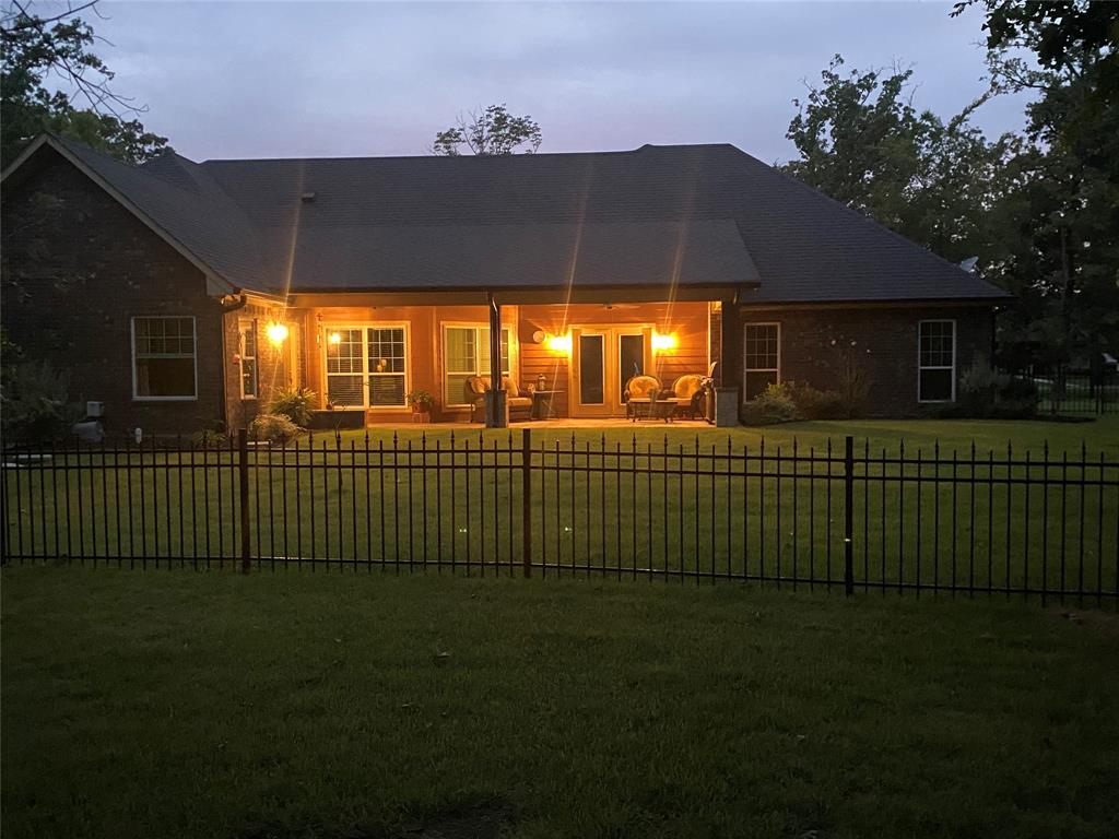 187 Private Road 5987 Yantis, TX 75497 - Photo 40 of 40 Back house at dusk featuring a patio area and a yard