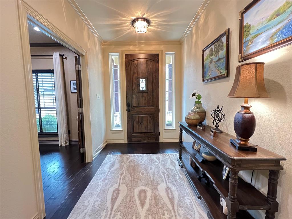 187 Private Road 5987 Yantis, TX 75497 - Photo 7 of 40 Entryway featuring crown molding and dark hardwood / wood-style floors