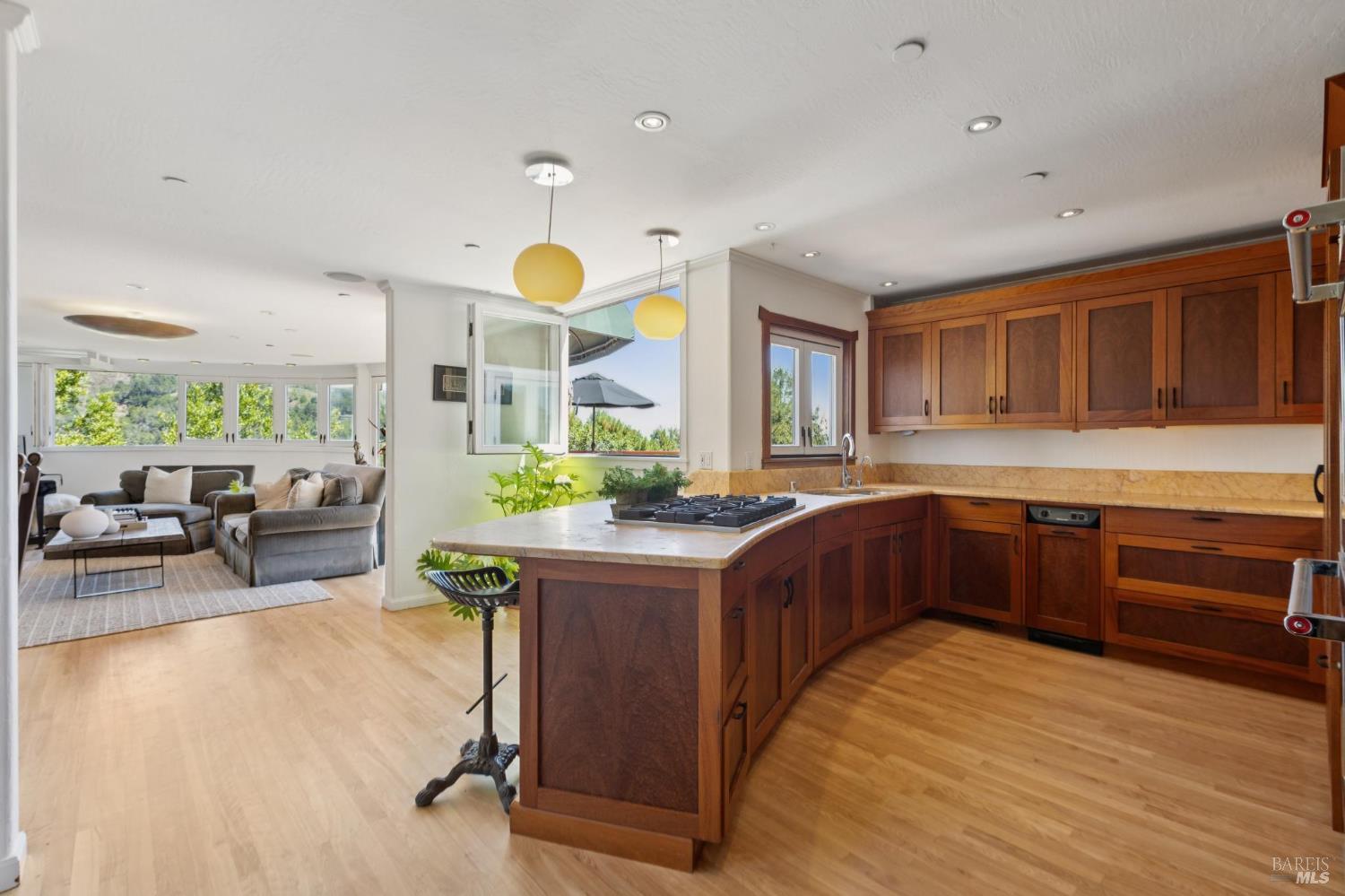 222 Marguerite Avenue Mill Valley, CA 94941 - Photo 19 of 59 a kitchen with stainless steel appliances granite countertop a stove a sink dishwasher oven a dining table and chairs with wooden floor