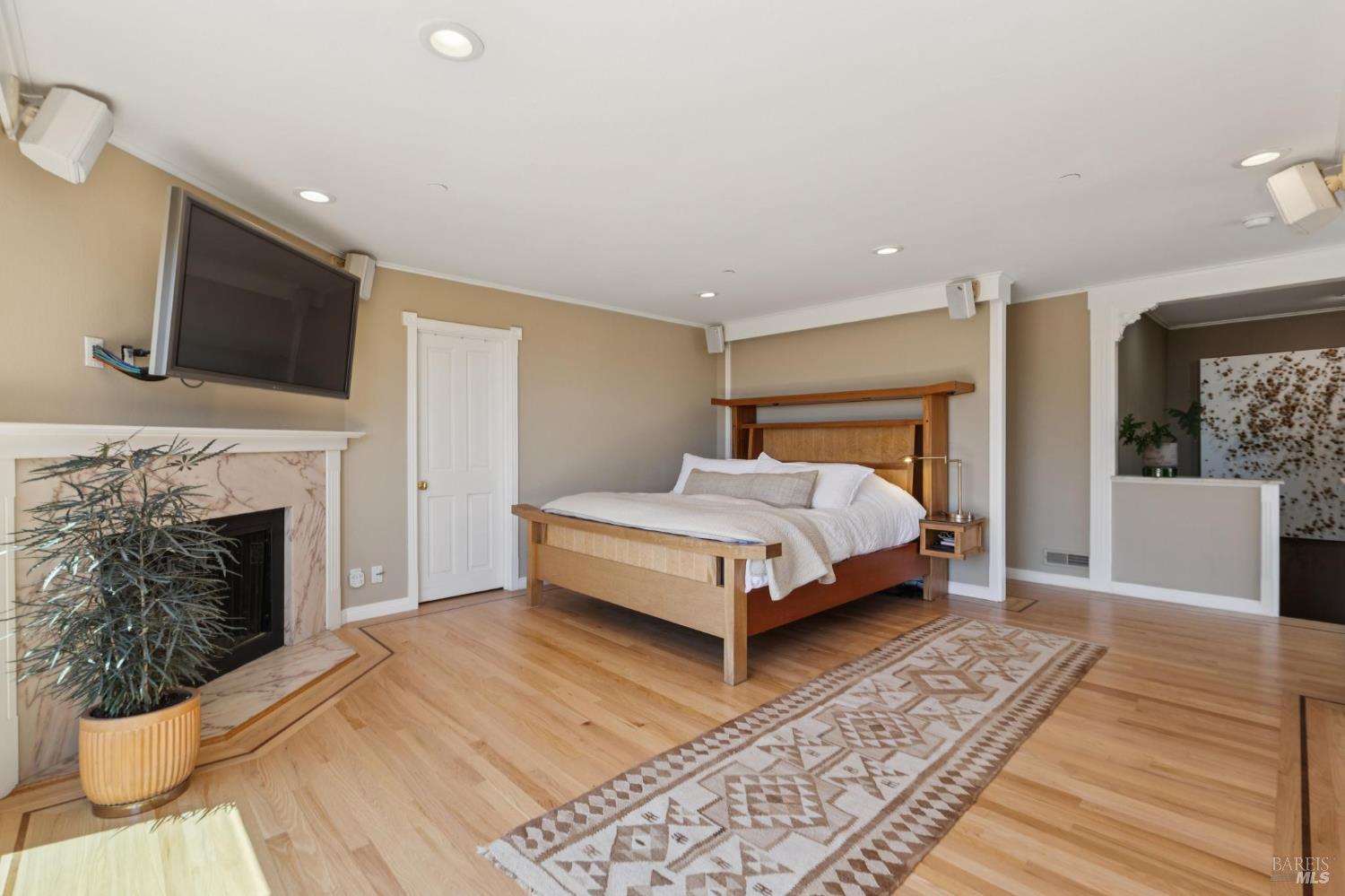 222 Marguerite Avenue Mill Valley, CA 94941 - Photo 28 of 59 a bedroom with a large bed a fireplace and a couch