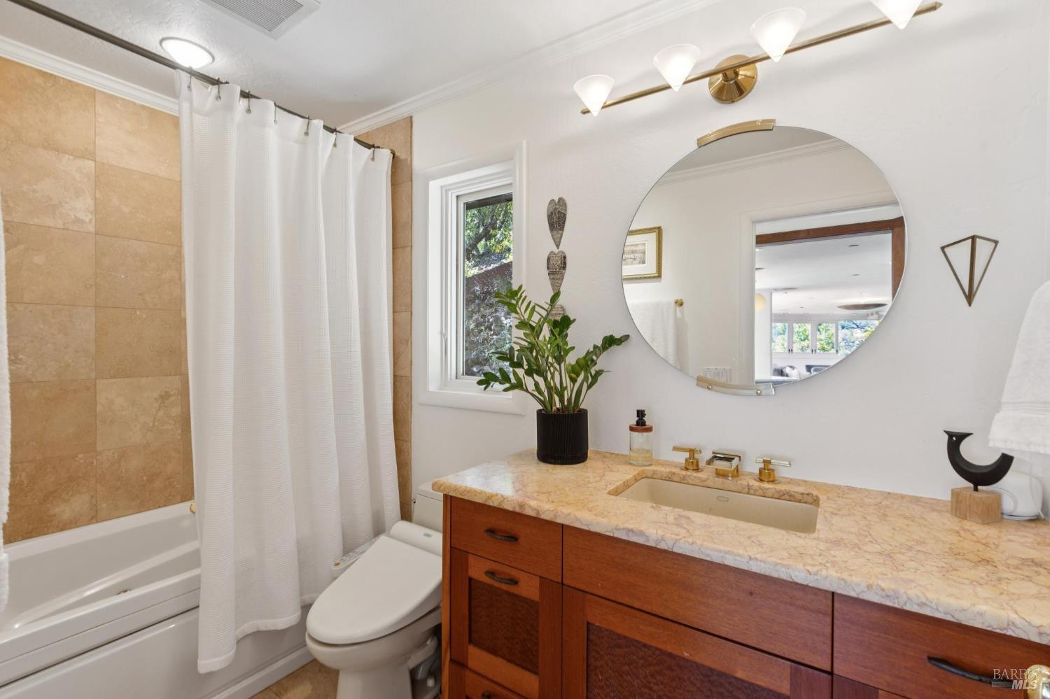 222 Marguerite Avenue Mill Valley, CA 94941 - Photo 44 of 59 a bathroom with a granite countertop sink toilet a mirror a vanity and shower