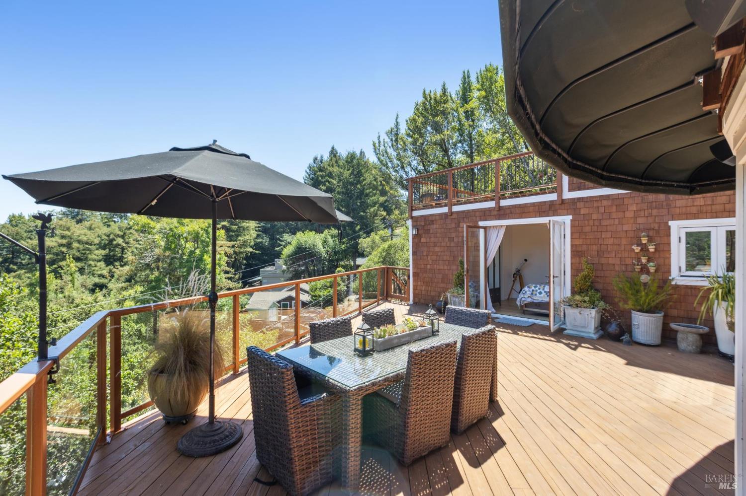 222 Marguerite Avenue Mill Valley, CA 94941 - Photo 5 of 59 a patio with wooden floor a yard a table and chairs
