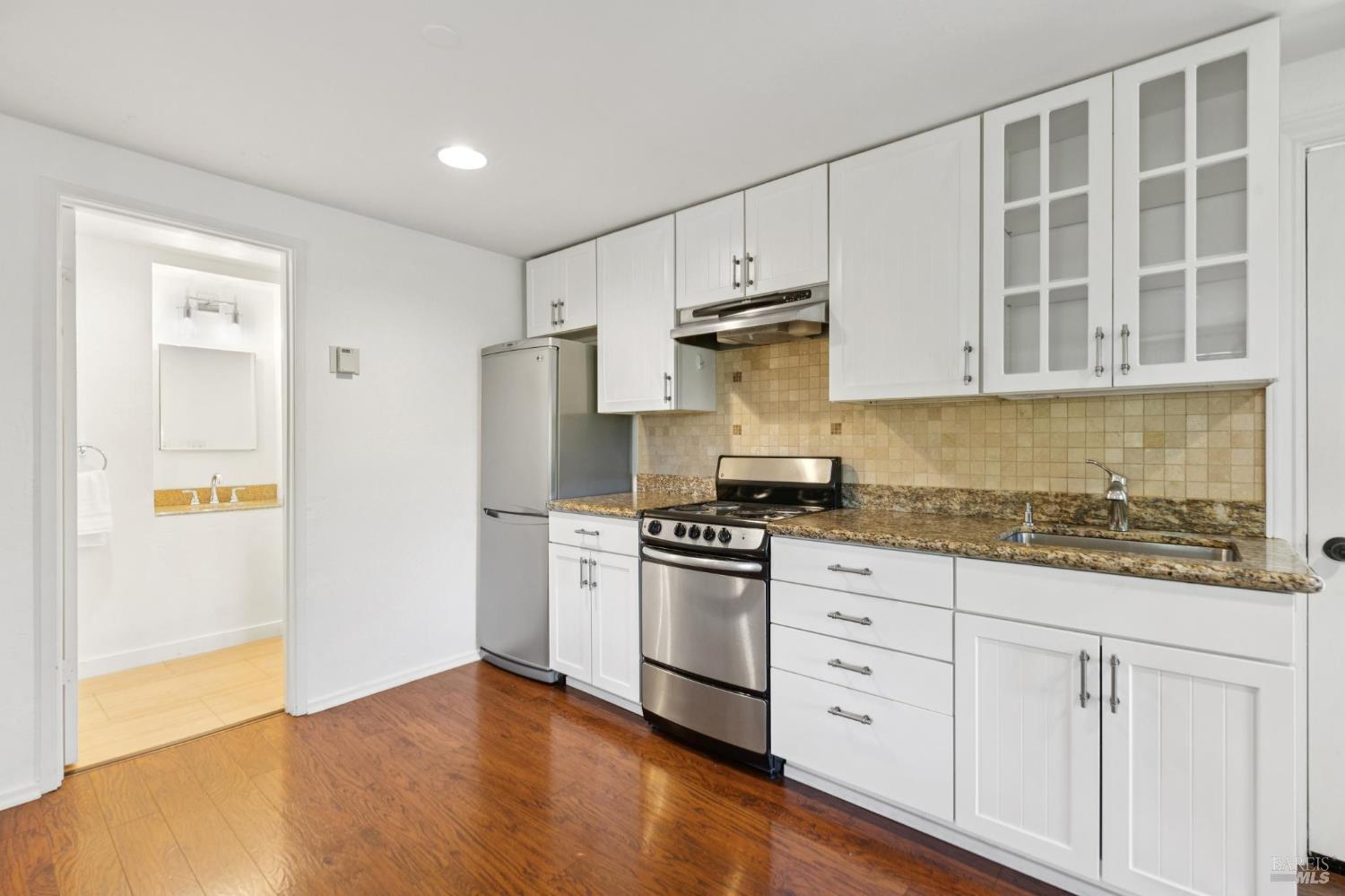 222 Marguerite Avenue Mill Valley, CA 94941 - Photo 52 of 59 a kitchen with granite countertop white cabinets and stainless steel appliances
