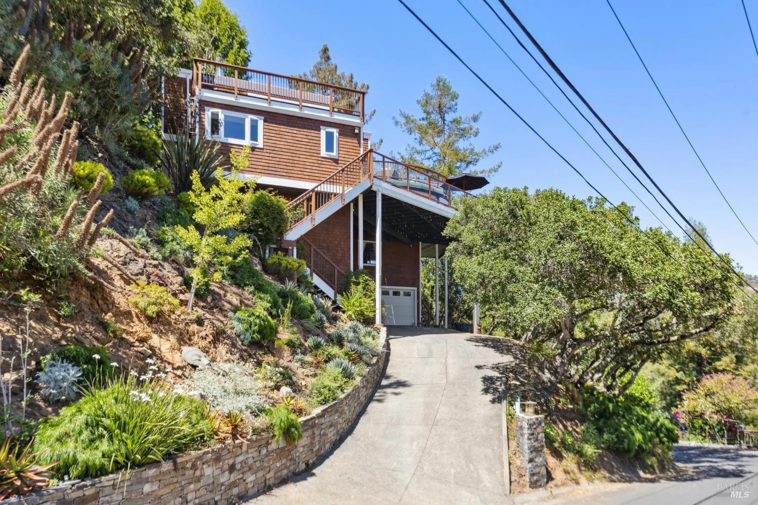 222 Marguerite Avenue Mill Valley, CA 94941 - Photo 55 of 59 a yellow house with a flower garden in front of it
