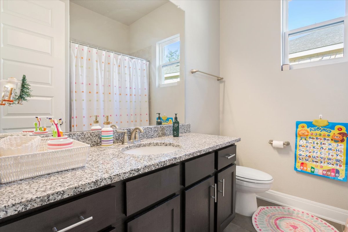 3814 Chance Loop Round Rock, TX 78628 - Photo 12 of 16 Bathroom featuring vanity and a shower with curtain