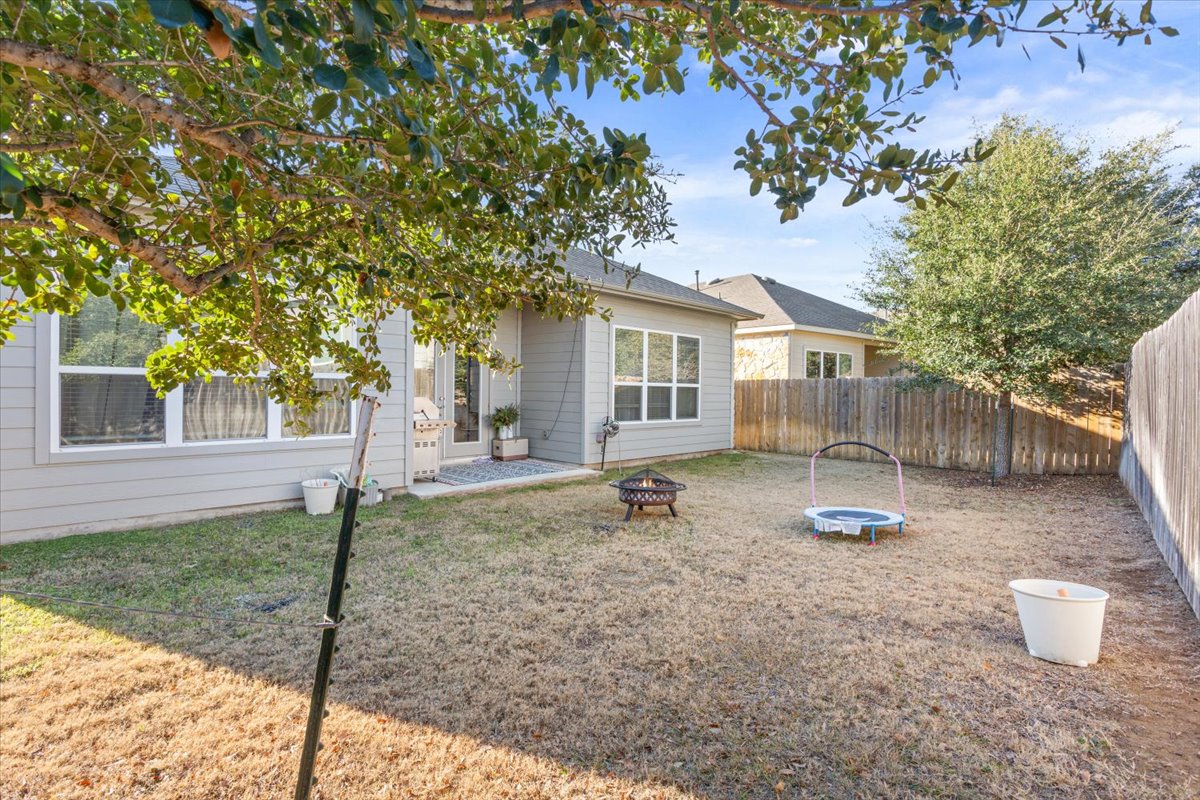 3814 Chance Loop Round Rock, TX 78628 - Photo 16 of 16 Back of house with an outdoor fire pit and a fenced backyard