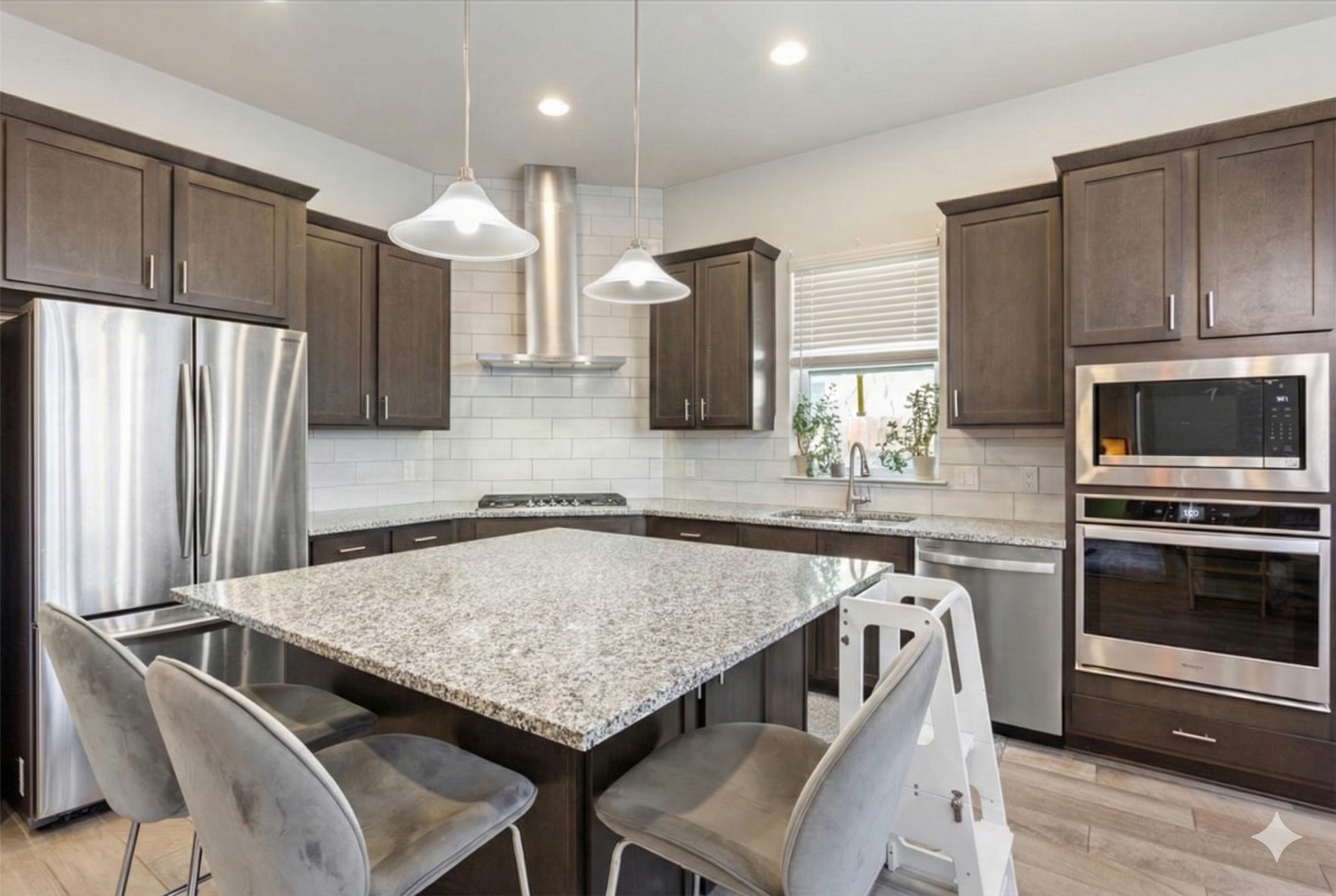 3814 Chance Loop Round Rock, TX 78628 - Photo 4 of 16 Kitchen featuring dark wood finish cabinetry, stainless steel appliances, a center island, a kitchen breakfast bar, and exhaust hood