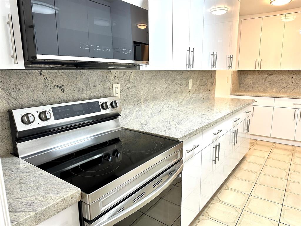 7355 West 4th Avenue, Unit 215 Hialeah, FL 33014 - Photo 1 of 17 a kitchen with granite countertop a stove and a sink