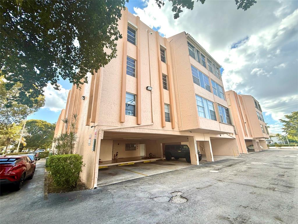 7355 West 4th Avenue, Unit 215 Hialeah, FL 33014 - Photo 17 of 17 a view of a blue house with a yard and sitting area