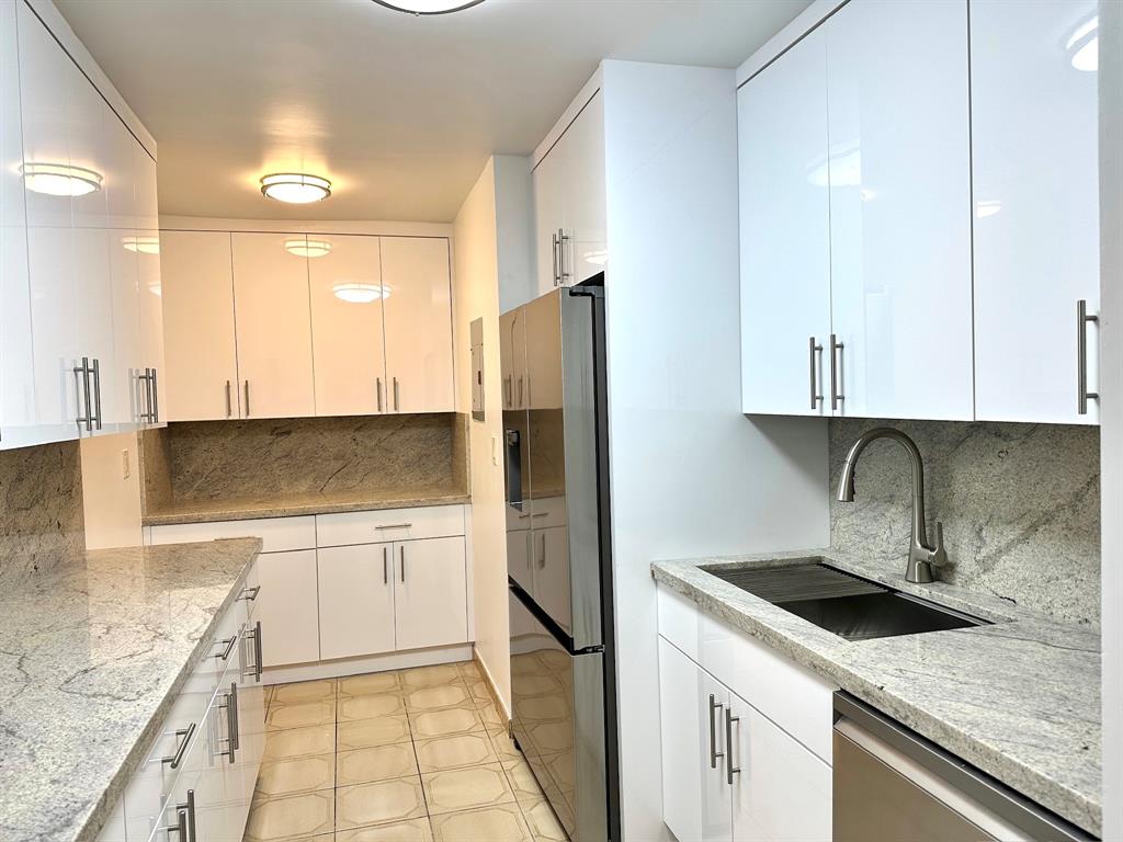 7355 West 4th Avenue, Unit 215 Hialeah, FL 33014 - Photo 2 of 17 a kitchen with a sink a refrigerator and a stove