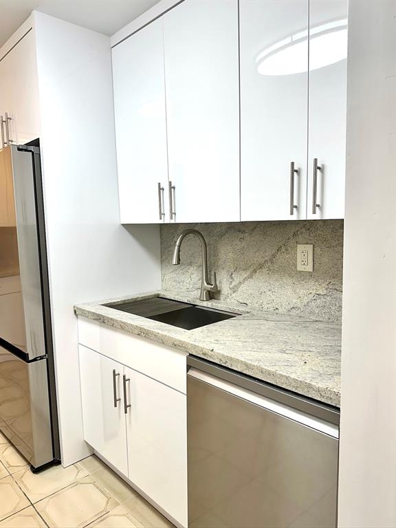 7355 West 4th Avenue, Unit 215 Hialeah, FL 33014 - Photo 3 of 17 a kitchen with stainless steel appliances granite countertop a sink stove and cabinets