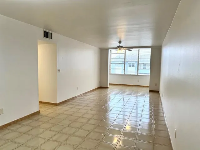 an empty room with windows and entrance