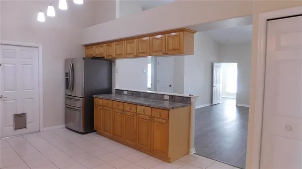 a kitchen with stainless steel appliances granite countertop a refrigerator and a sink