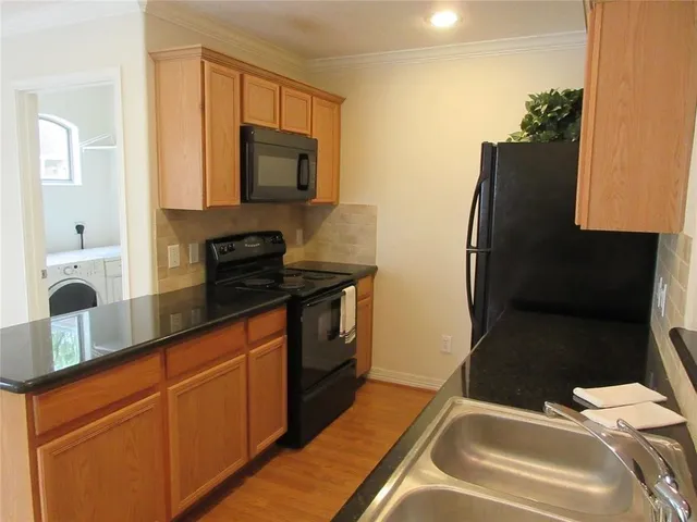 a kitchen with a sink and a refrigerator