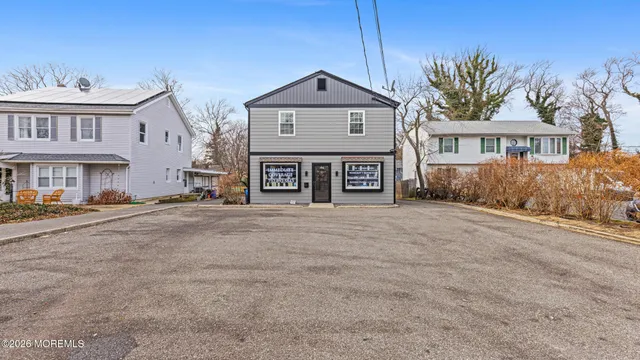 a front view of a building with a yard
