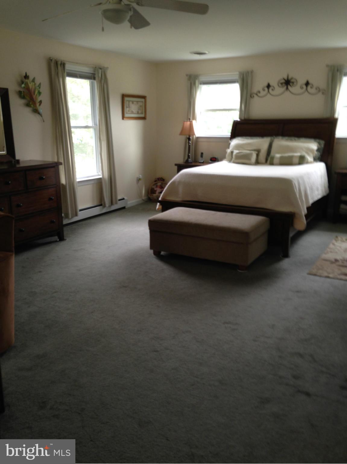 1355 Jewell Road Dunkirk, MD 20754 - Photo 16 of 30 a spacious bedroom with a bed and a chandelier