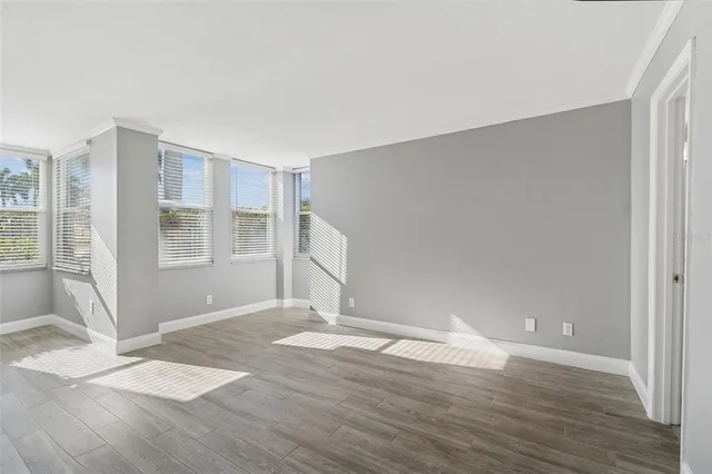 a view of an empty room with wooden floor