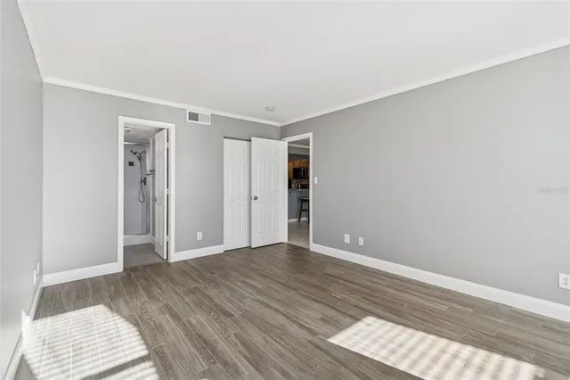 a living room with furniture a floor to ceiling window and gym equipment