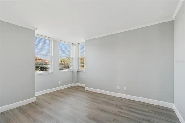 a view of an empty room with wooden floor