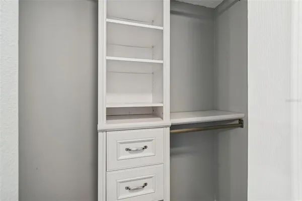 a bathroom with a bathtub shower sink vanity mirror and toilet