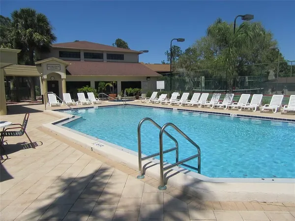 front view of house with a swimming pool and porch