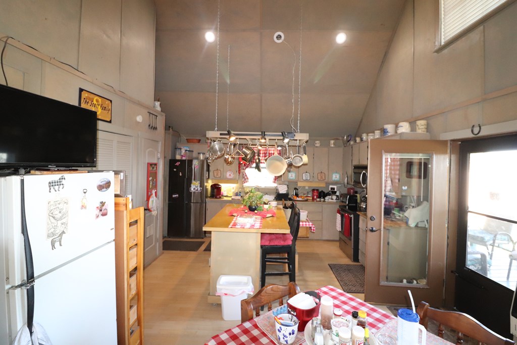 48 SD 14070 Rocksprings, TX 78880 - Photo 7 of 11 a hallway view with fireplace a flat screen tv and a refrigerator