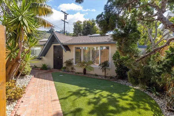 a backyard of a house with plants and garden