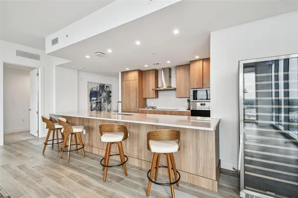 a kitchen with stainless steel appliances a sink stove and cabinets