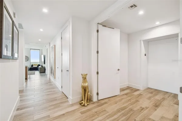 a large kitchen with stainless steel appliances kitchen island granite countertop a table and chairs in it