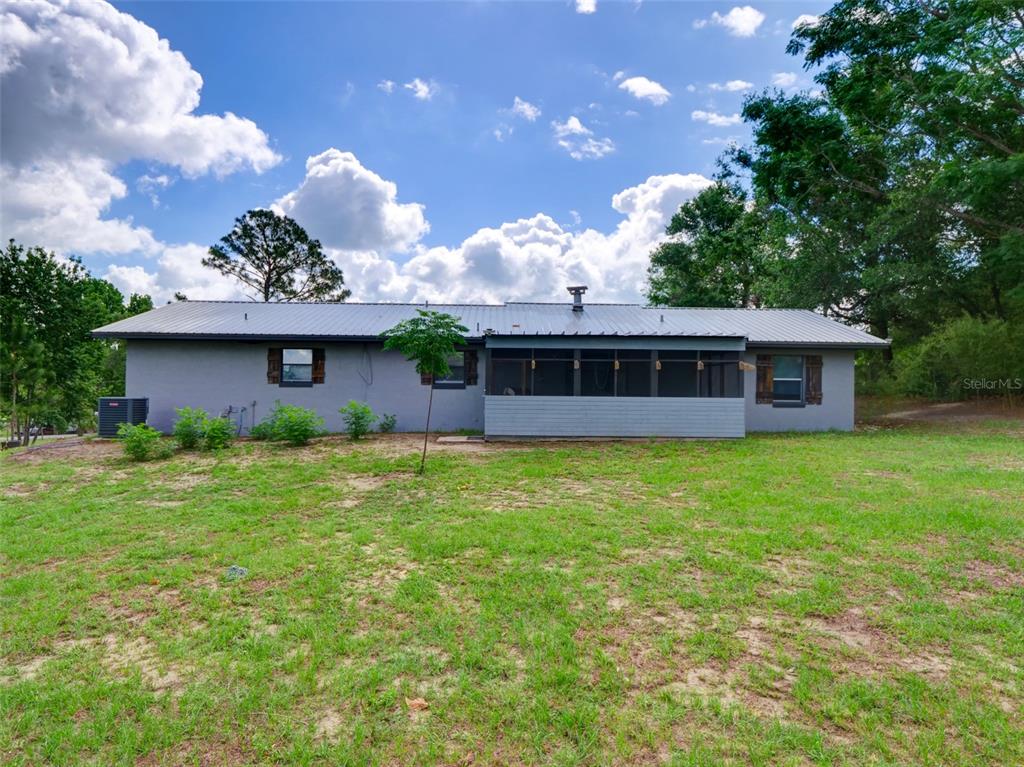 37149 Grays Airport Road Lady Lake, FL 32159 - Photo 24 of 36 a front view of a house with a garden