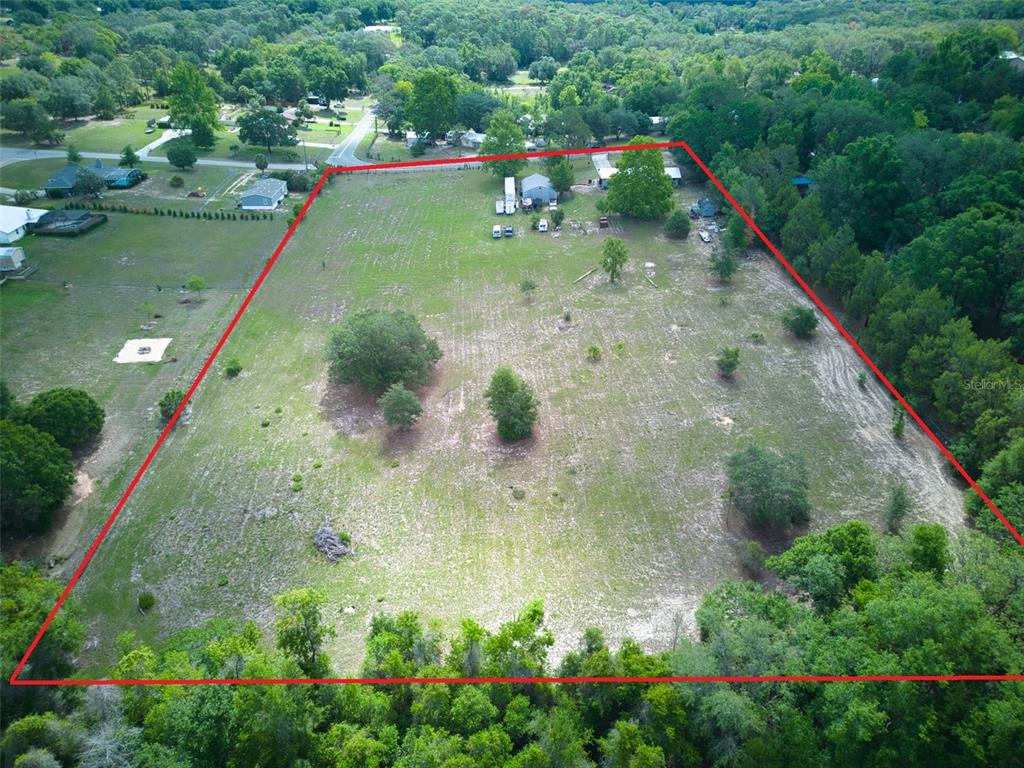 37149 Grays Airport Road Lady Lake, FL 32159 - Photo 29 of 36 a view of a garden with a lake view