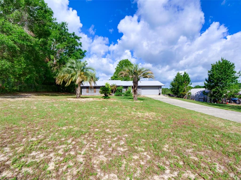 37149 Grays Airport Road Lady Lake, FL 32159 - Photo 3 of 36 a view of yard with swimming pool and green space