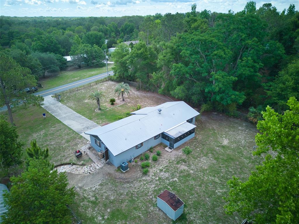 37149 Grays Airport Road Lady Lake, FL 32159 - Photo 31 of 36 a view of a backyard with a barn