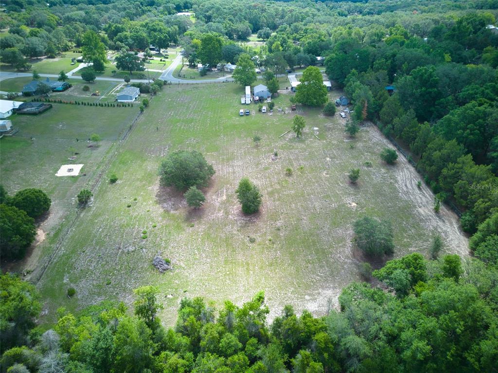 37149 Grays Airport Road Lady Lake, FL 32159 - Photo 35 of 36 a view of a lake with huge green field and trees