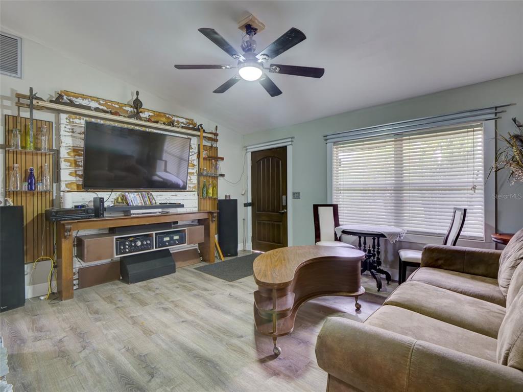 37149 Grays Airport Road Lady Lake, FL 32159 - Photo 5 of 36 a living room with furniture and a flat screen tv