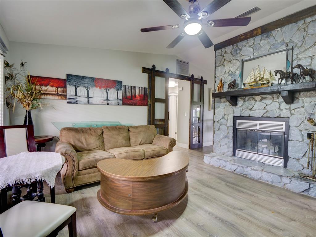 37149 Grays Airport Road Lady Lake, FL 32159 - Photo 6 of 36 a living room with furniture and a fireplace