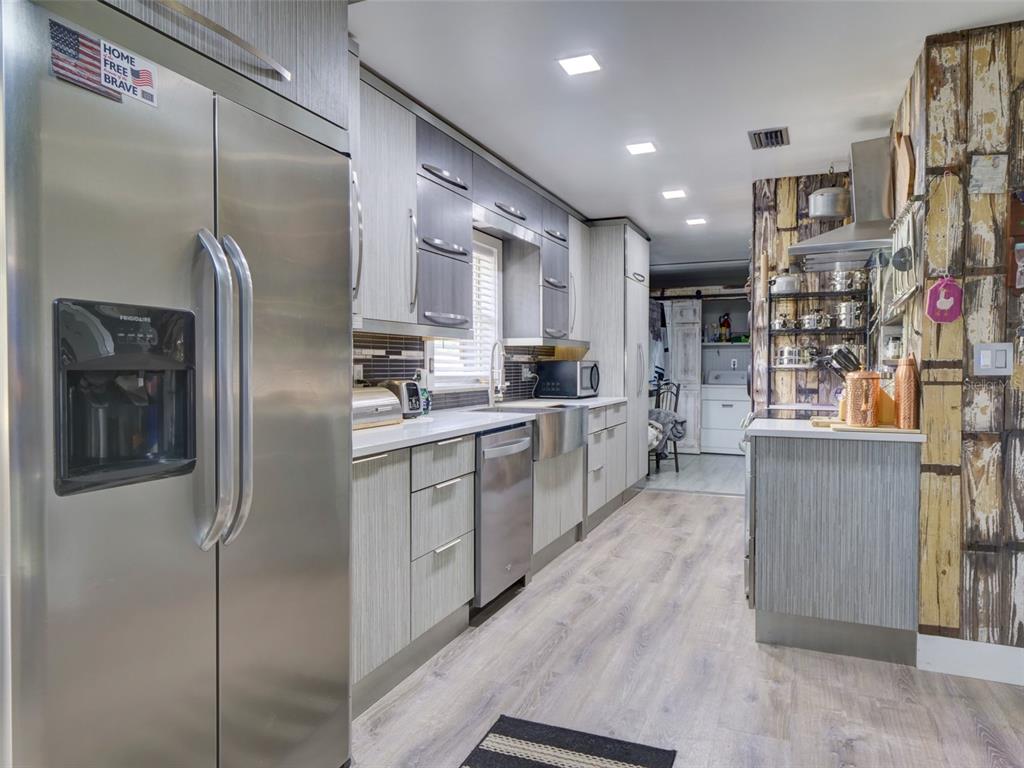 37149 Grays Airport Road Lady Lake, FL 32159 - Photo 7 of 36 a kitchen with stainless steel appliances granite countertop a refrigerator and a sink