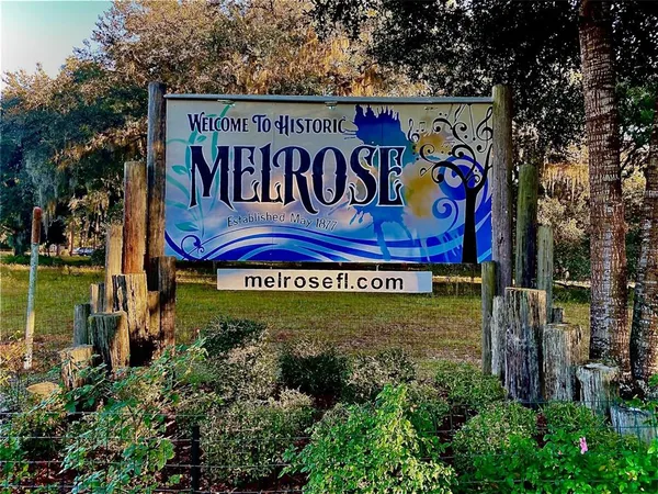 a sign broad in front of flowers