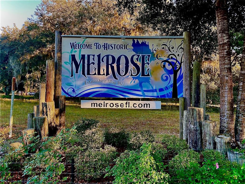 Trout Street Melrose, FL 32666 - Photo 2 of 41 a sign broad in front of flowers