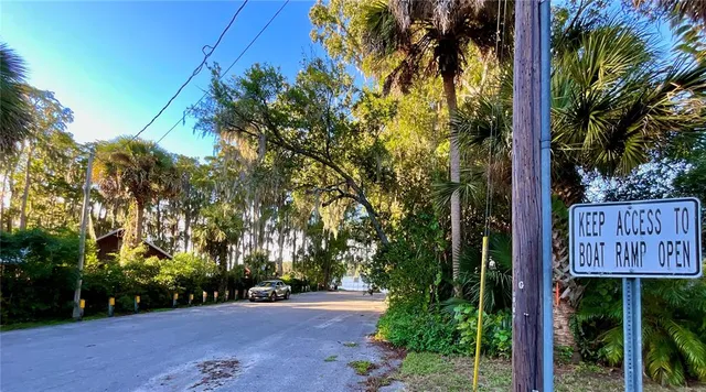a sign board with a yard and plants