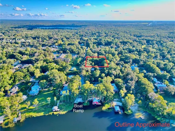 an aerial view of a house with a yard