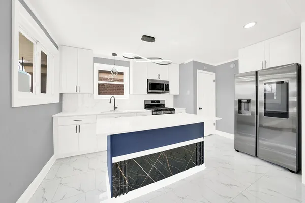 a kitchen with stainless steel appliances a sink stove and refrigerator