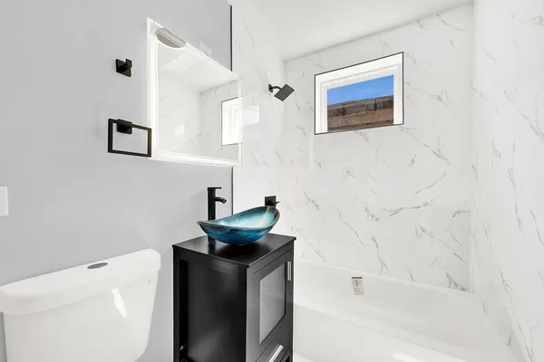 a bathroom with a sink a toilet and bathtub