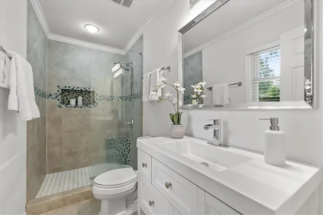 a bathroom with a sink toilet and shower