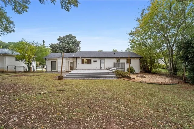 a front view of a house with a garden and yard